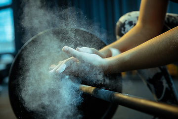 Image showing Caucasian teenage girl practicing in weightlifting in gym