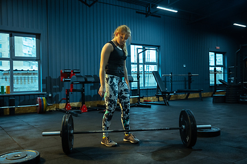 Image showing Caucasian teenage girl practicing in weightlifting in gym