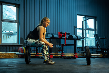 Image showing Caucasian teenage girl practicing in weightlifting in gym