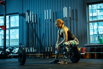 Image showing Caucasian teenage girl practicing in weightlifting in gym