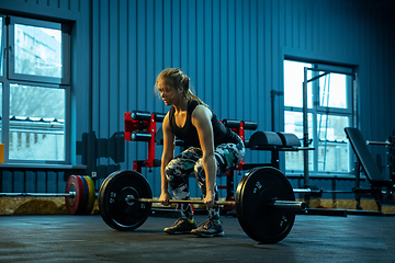 Image showing Caucasian teenage girl practicing in weightlifting in gym