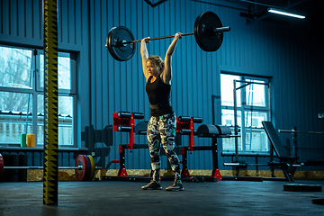 Image showing Caucasian teenage girl practicing in weightlifting in gym