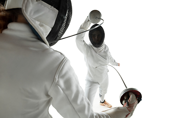 Image showing Teen girls in fencing costumes with swords in hands isolated on white background