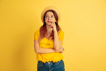 Image showing Caucasian woman\'s portrait isolated on yellow studio background