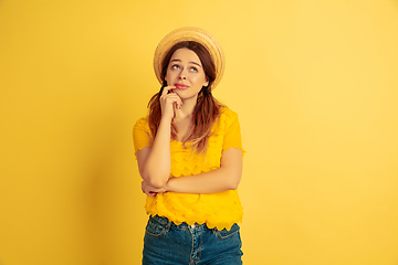 Image showing Caucasian woman\'s portrait isolated on yellow studio background