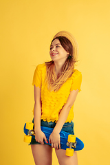 Image showing Caucasian woman\'s portrait isolated on yellow studio background