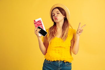 Image showing Caucasian woman\'s portrait isolated on yellow studio background