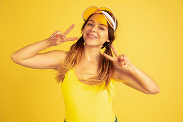 Image showing Caucasian woman\'s portrait isolated on yellow studio background