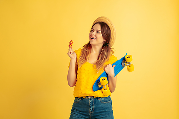 Image showing Caucasian woman\'s portrait isolated on yellow studio background