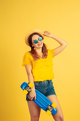 Image showing Caucasian woman\'s portrait isolated on yellow studio background