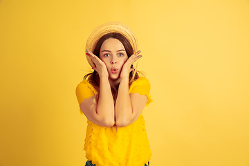 Image showing Caucasian woman\'s portrait isolated on yellow studio background