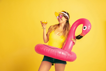 Image showing Caucasian woman\'s portrait isolated on yellow studio background