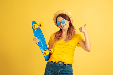 Image showing Caucasian woman\'s portrait isolated on yellow studio background