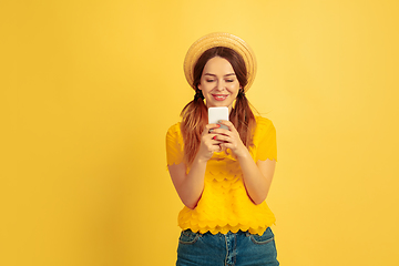 Image showing Caucasian woman\'s portrait isolated on yellow studio background