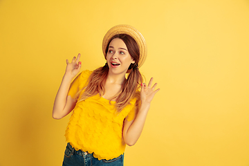 Image showing Caucasian woman\'s portrait isolated on yellow studio background