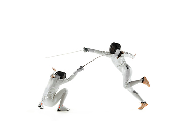 Image showing Teen girls in fencing costumes with swords in hands isolated on white background