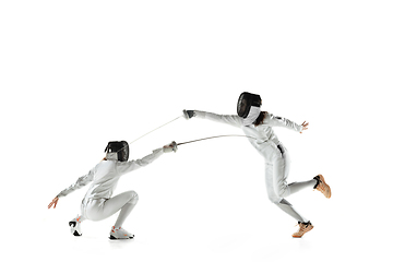 Image showing Teen girls in fencing costumes with swords in hands isolated on white background