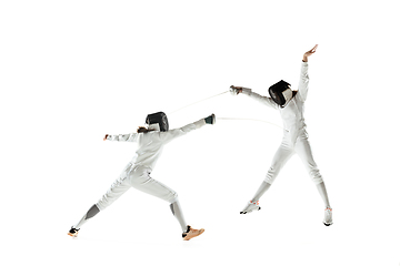 Image showing Teen girls in fencing costumes with swords in hands isolated on white background