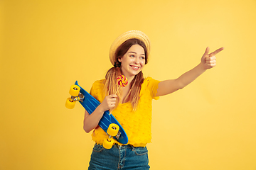 Image showing Caucasian woman\'s portrait isolated on yellow studio background