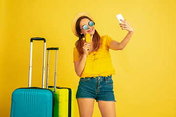 Image showing Caucasian woman\'s portrait isolated on yellow studio background