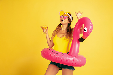 Image showing Caucasian woman\'s portrait isolated on yellow studio background