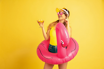 Image showing Caucasian woman\'s portrait isolated on yellow studio background