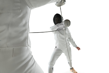 Image showing Teen girls in fencing costumes with swords in hands isolated on white background