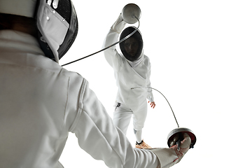 Image showing Teen girls in fencing costumes with swords in hands isolated on white background