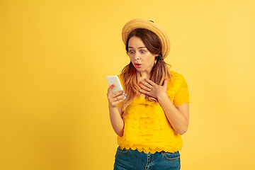 Image showing Caucasian woman\'s portrait isolated on yellow studio background