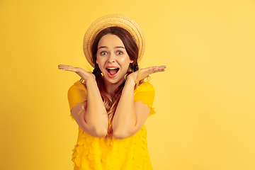 Image showing Caucasian woman\'s portrait isolated on yellow studio background