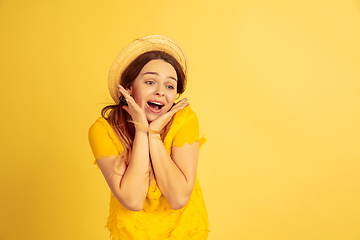 Image showing Caucasian woman\'s portrait isolated on yellow studio background