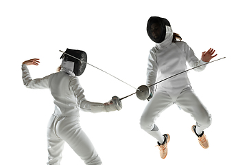 Image showing Teen girls in fencing costumes with swords in hands isolated on white background