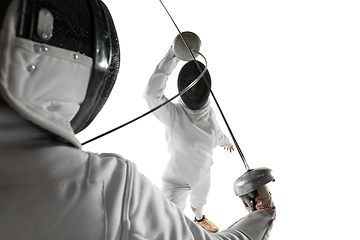 Image showing Teen girls in fencing costumes with swords in hands isolated on white background