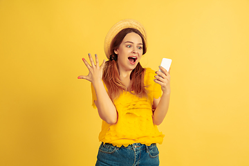 Image showing Caucasian woman\'s portrait isolated on yellow studio background