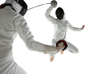 Image showing Teen girls in fencing costumes with swords in hands isolated on white background