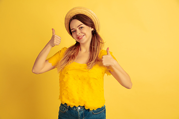 Image showing Caucasian woman\'s portrait isolated on yellow studio background