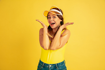 Image showing Caucasian woman\'s portrait isolated on yellow studio background