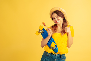 Image showing Caucasian woman\'s portrait isolated on yellow studio background