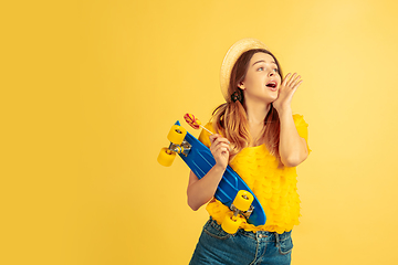 Image showing Caucasian woman\'s portrait isolated on yellow studio background