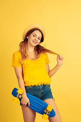 Image showing Caucasian woman\'s portrait isolated on yellow studio background