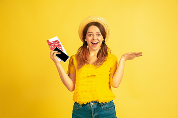 Image showing Caucasian woman\'s portrait isolated on yellow studio background