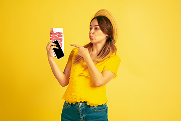 Image showing Caucasian woman\'s portrait isolated on yellow studio background