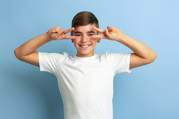 Image showing Caucasian teen\'s portrait isolated on blue studio background