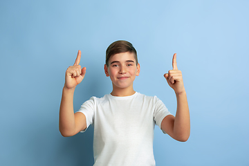 Image showing Caucasian teen\'s portrait isolated on blue studio background