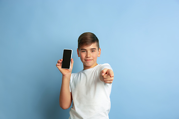 Image showing Caucasian teen\'s portrait isolated on blue studio background