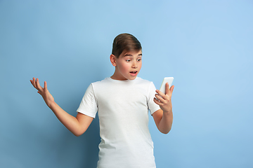 Image showing Caucasian teen\'s portrait isolated on blue studio background