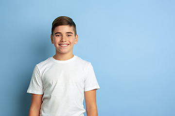 Image showing Caucasian teen\'s portrait isolated on blue studio background