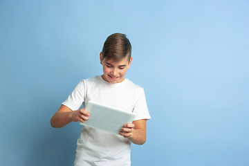 Image showing Caucasian teen\'s portrait isolated on blue studio background