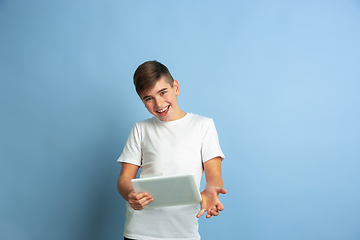 Image showing Caucasian teen\'s portrait isolated on blue studio background