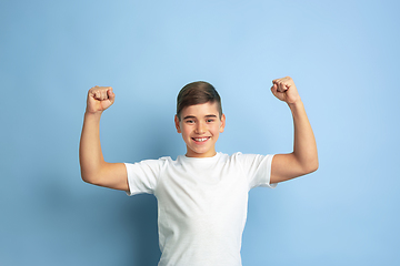 Image showing Caucasian teen\'s portrait isolated on blue studio background